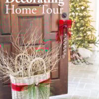 Foyer door open with red ribbon tied sleigh bells and basket. Text overlay says Christmas decorating home tour