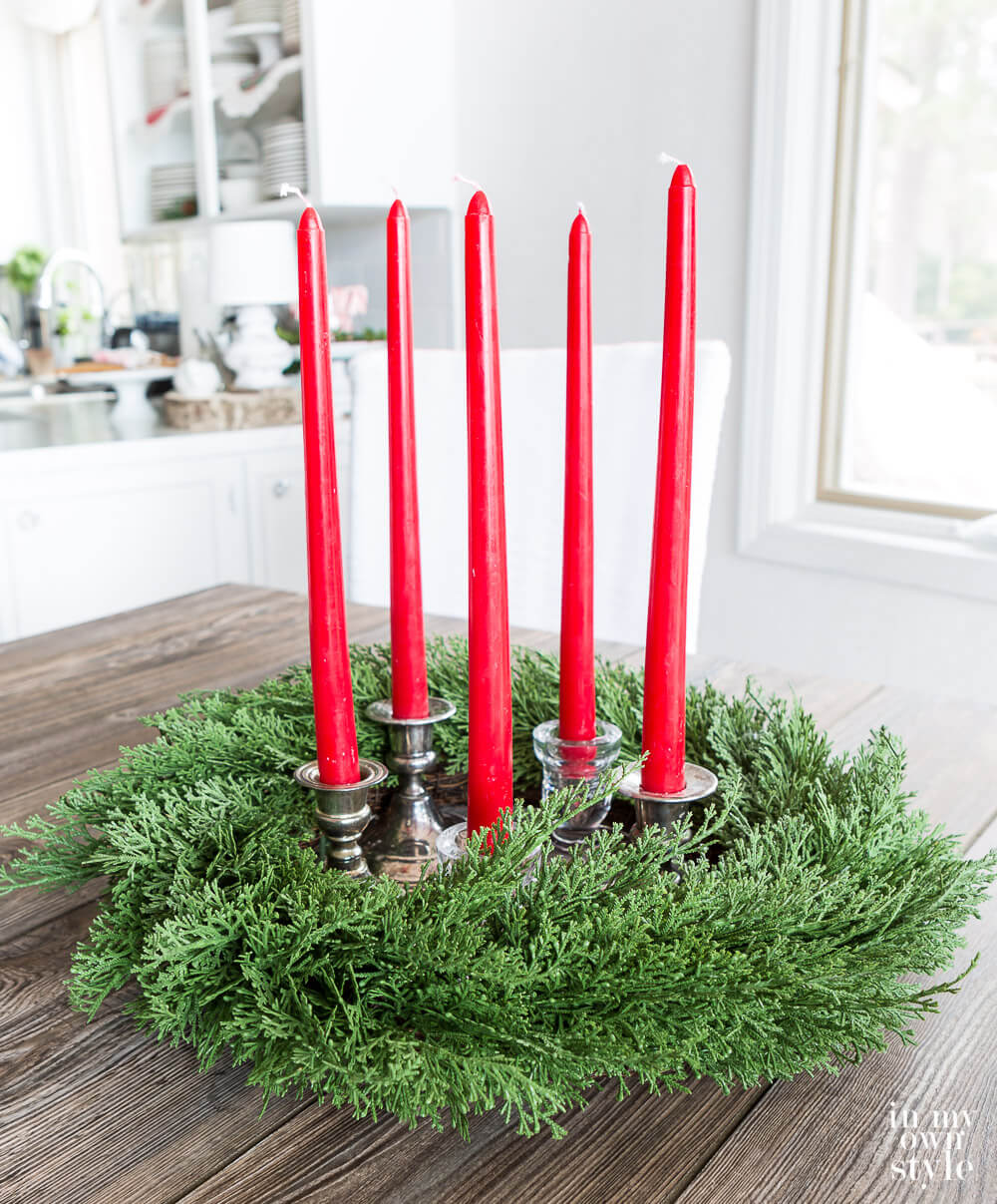 Wreath with red taper candles inside to make a centerpiece