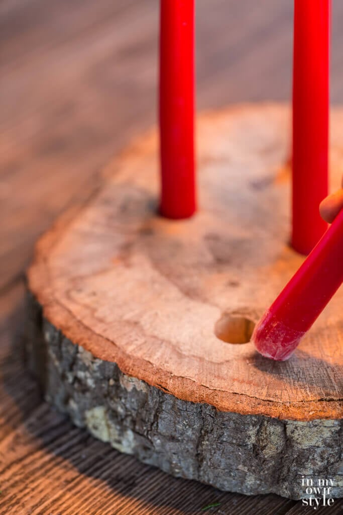 How to place a candle in a drilled hole to create a tree trunk candle holder.