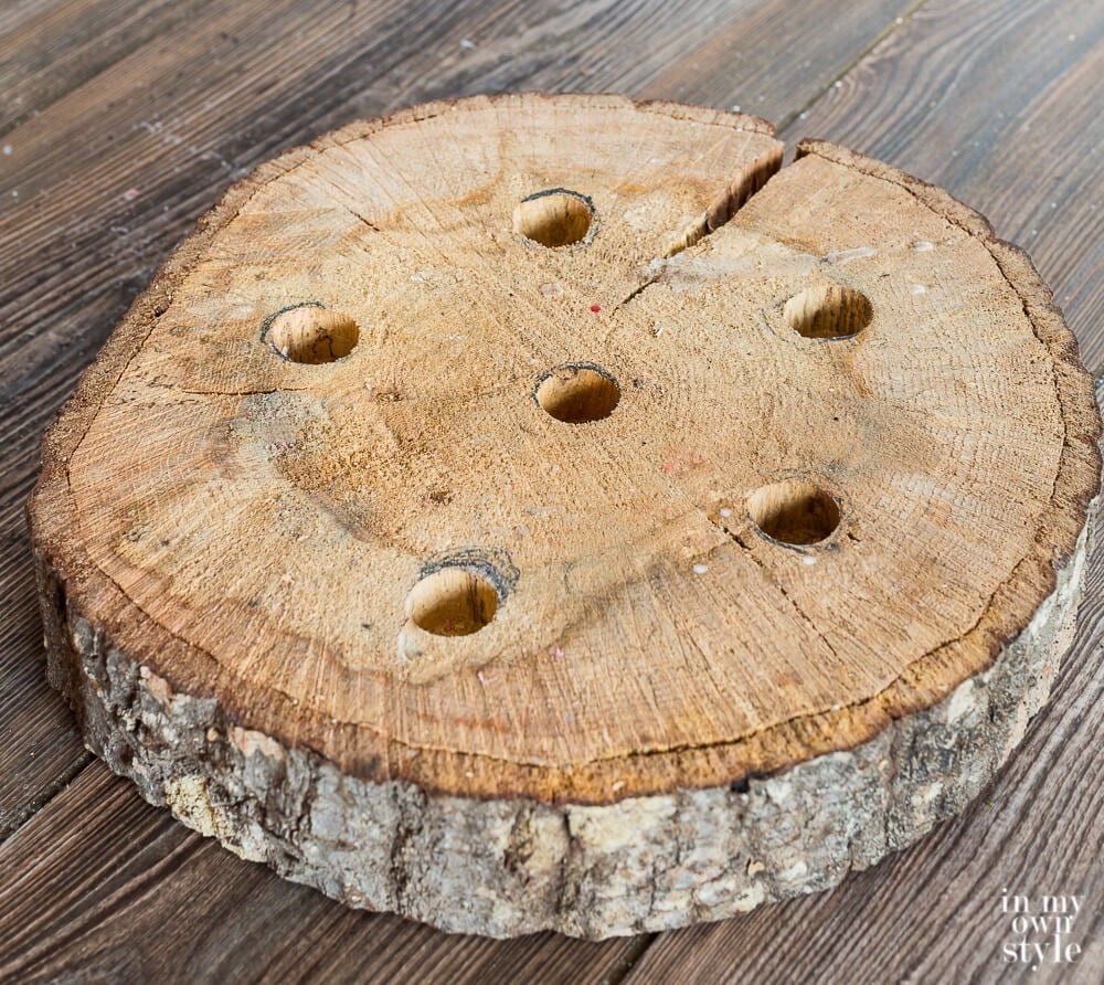 Tree trunk slice with holes drilled in for taper candles.