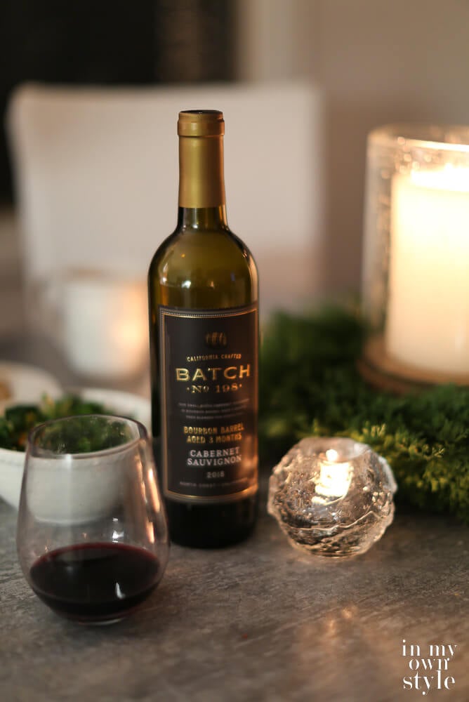 wine on table with candles and glasses