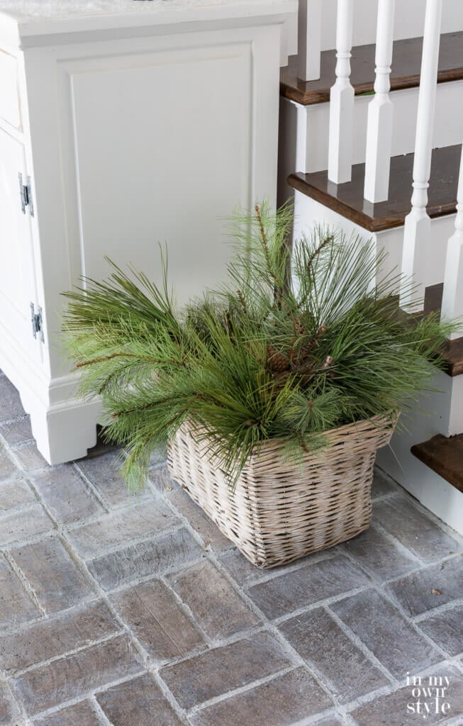 basket of greenery on floor in foyer