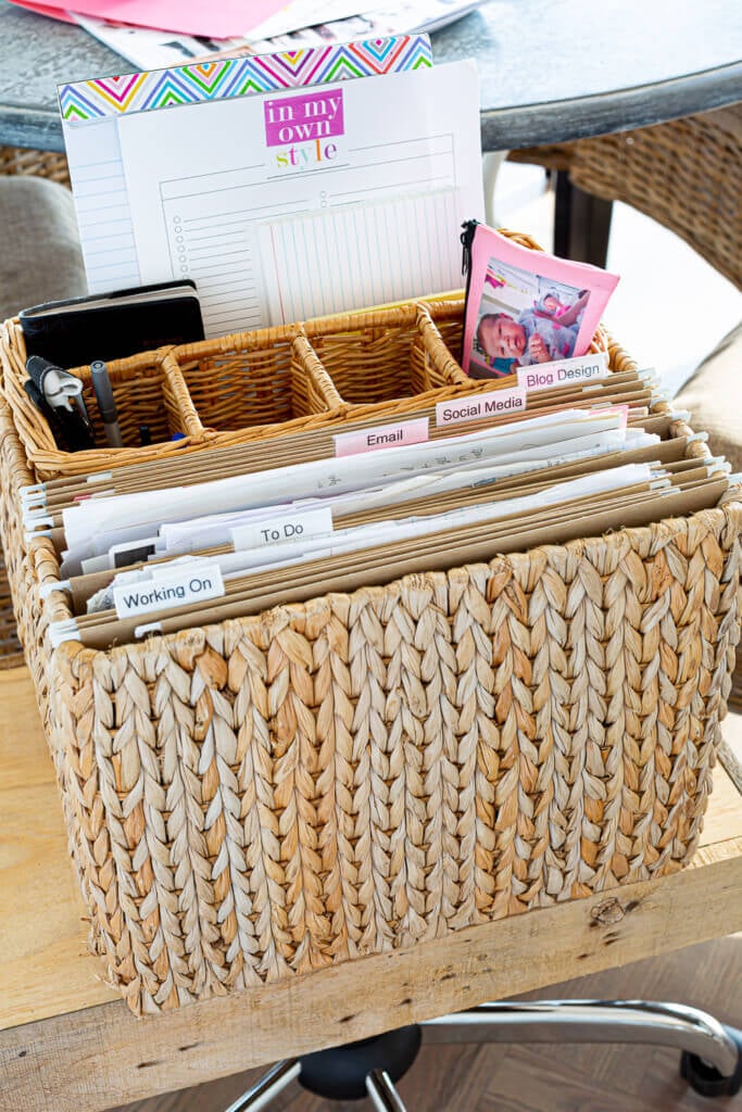 Hanging file folder holder with a basket inside to hold office supplies is a creative file storage idea for when you work from home.