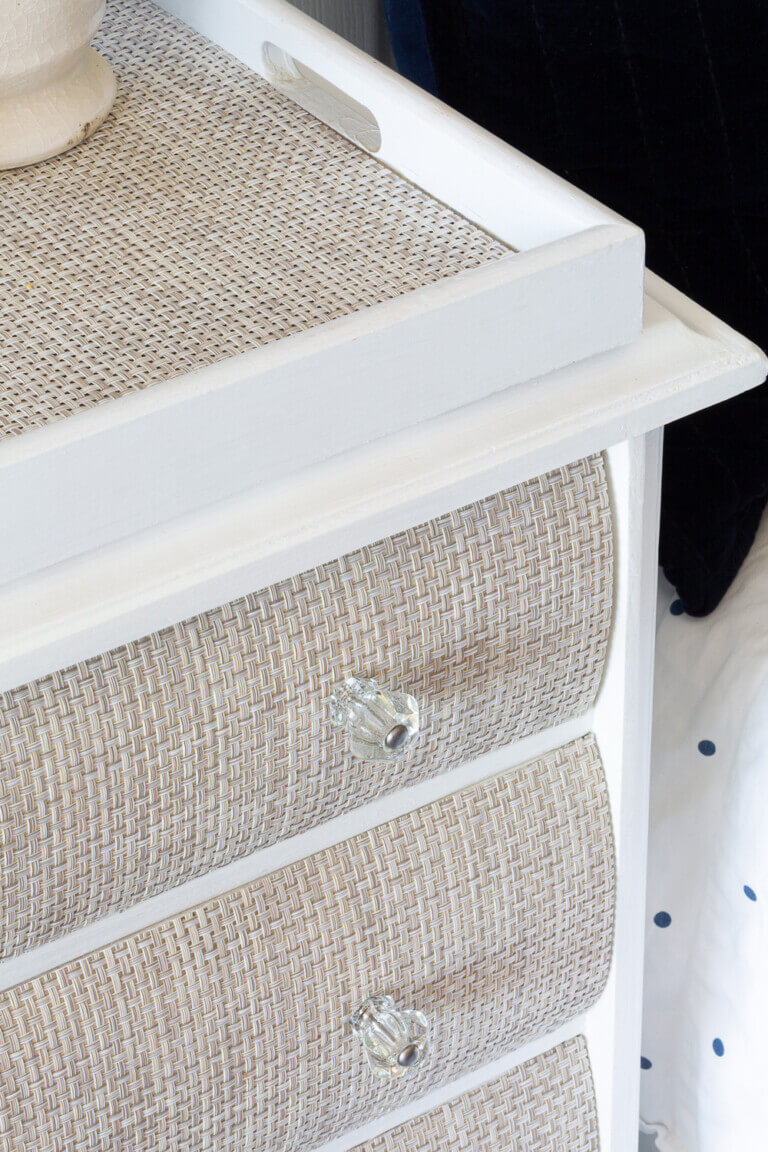 placemat in tray on woven drawer fronted nightstand