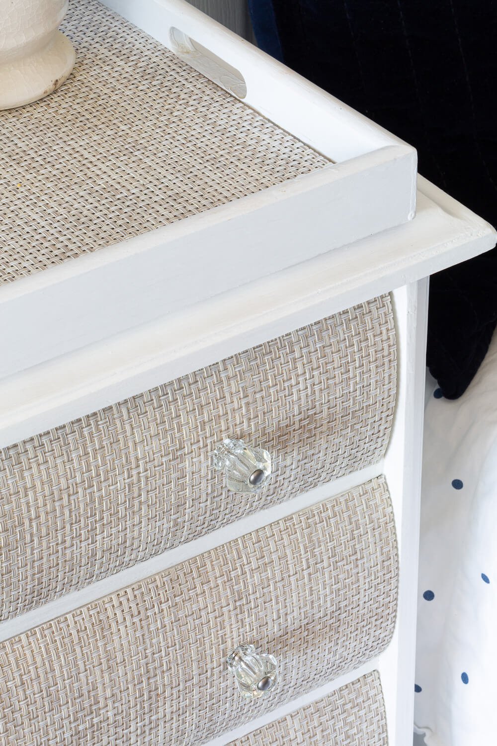 placemat in tray on woven drawer fronted nightstand