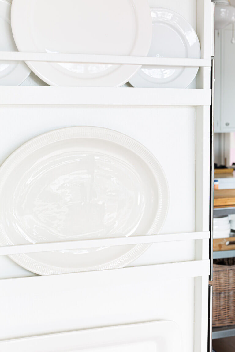 Close up of plate rack in kitchen.