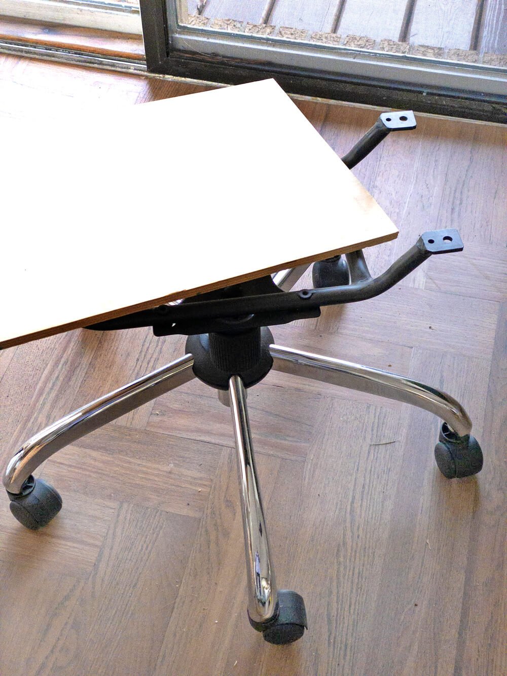 Office chair base being transformed to hold a hanging file folder organizer for use when working from home.