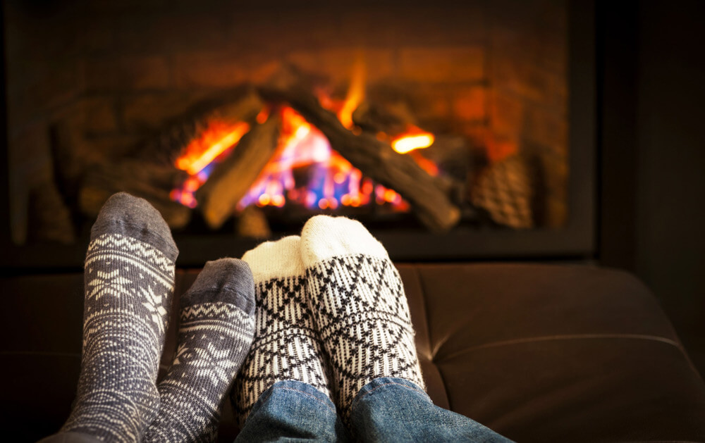 two-socked-pairs-of-feet-cozy-by-the-fire