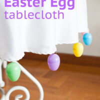 Easter decor table idea. Text overlay says colorful Easter egg tablecloth.