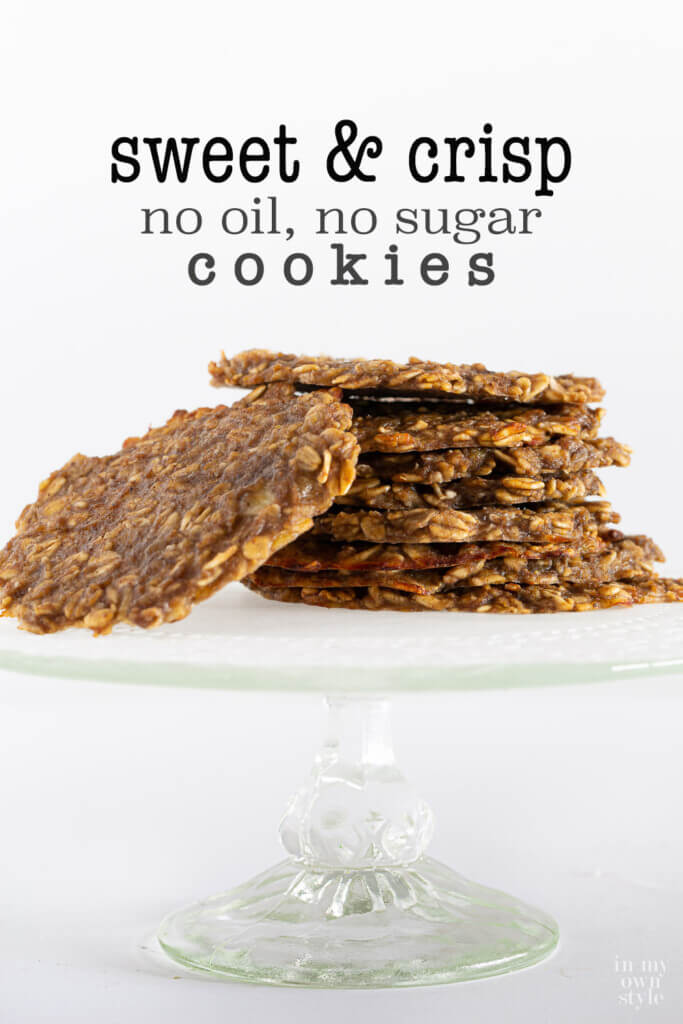 Thin oatmeal banana cookies stacked on a cake stand. Text overlay says sweet and crisp no oil no sugar cookies