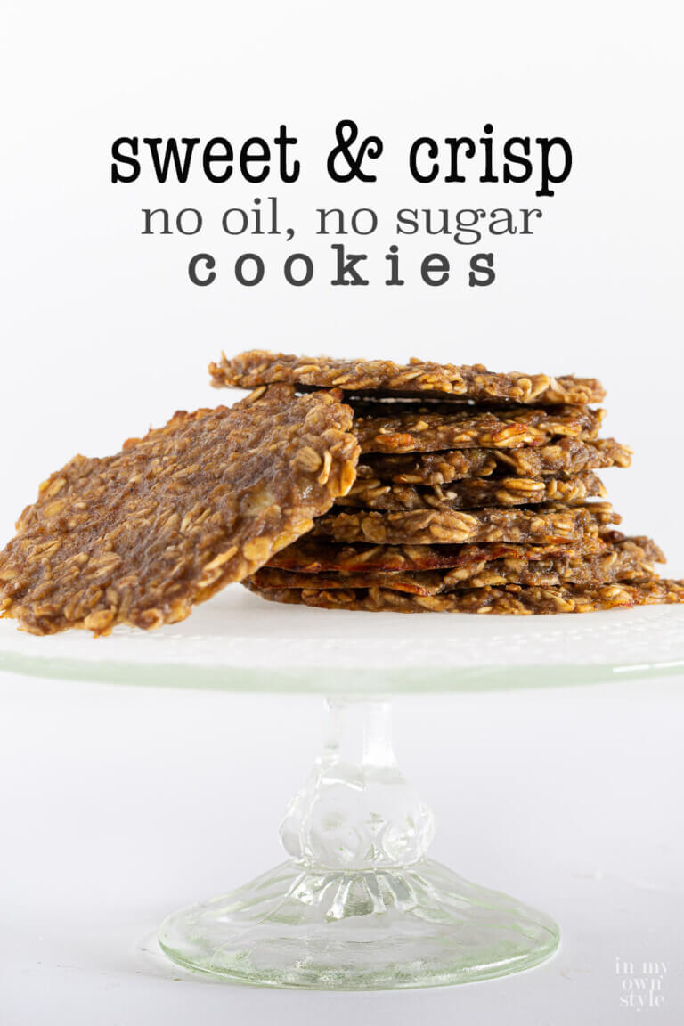 Thin oatmeal banana cookies stacked on a cake stand. Text overlay says sweet and crisp no oil no sugar cookies