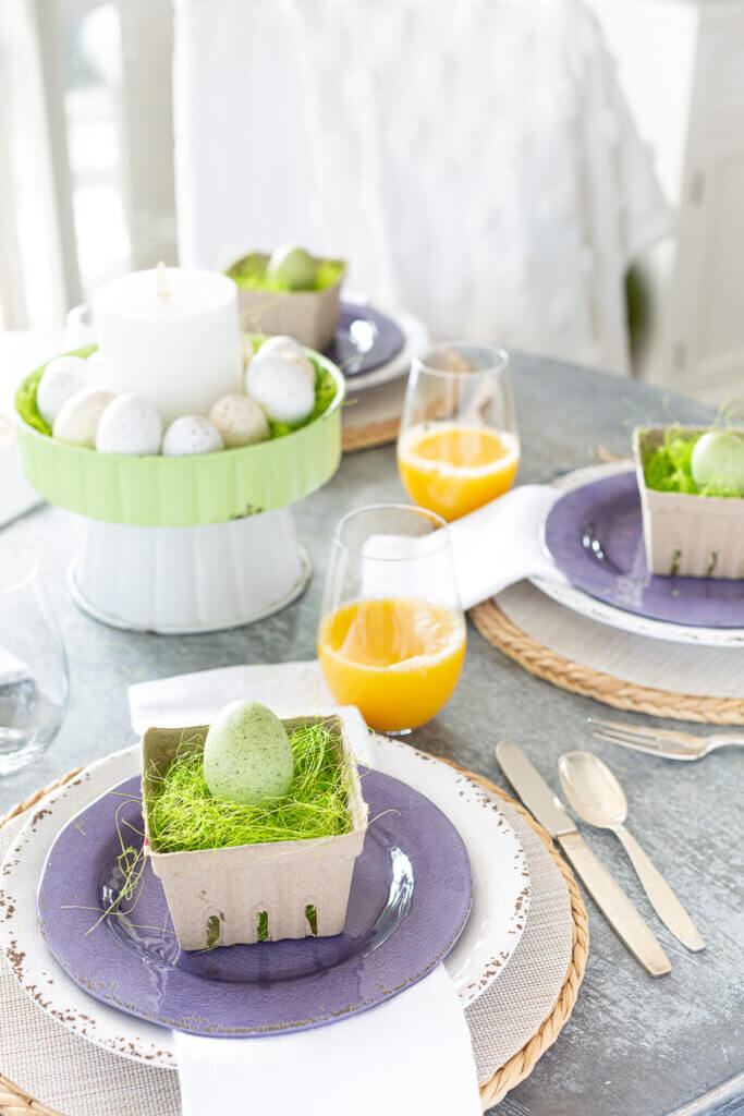Easter Brunch table decorations. Purple, pale green and white spring color theme..
