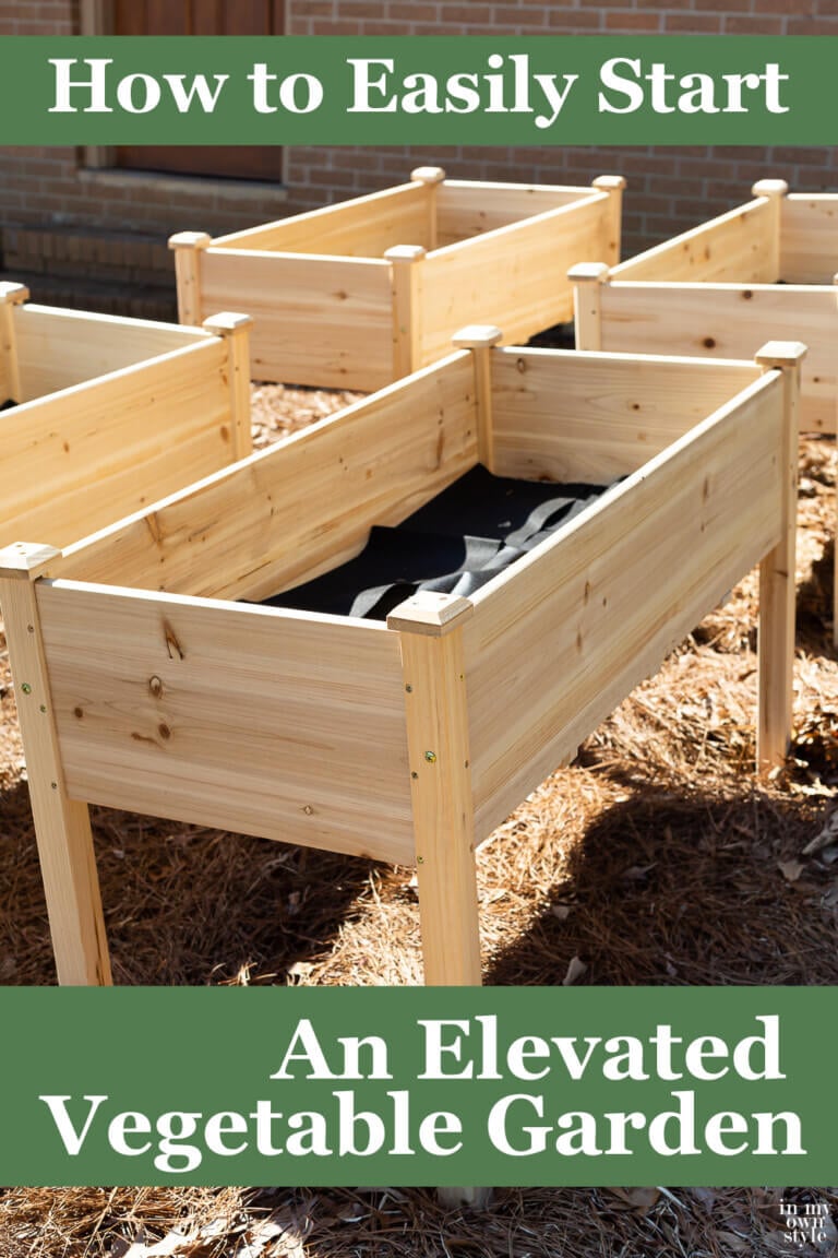 4 elevated cedar garden planters in yard. Text overlay says How to easily start an elevated vegetable garden
