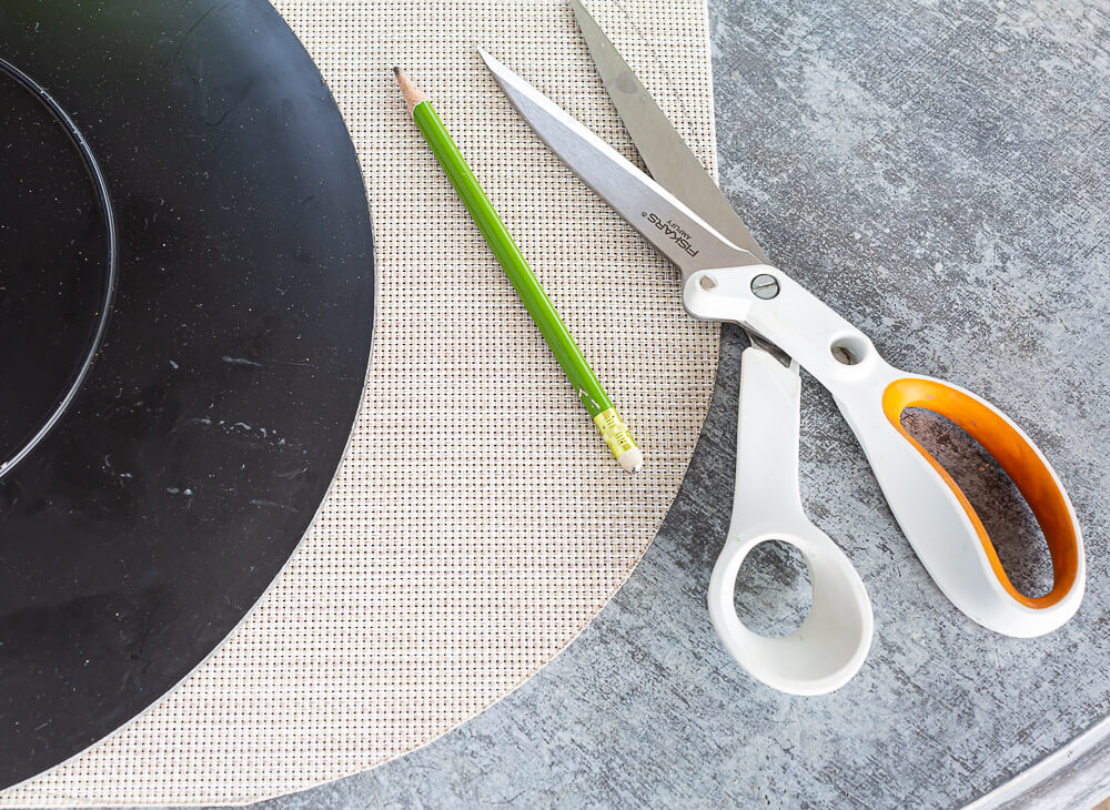 How to make a round template and cut a woven placemat to make it round.