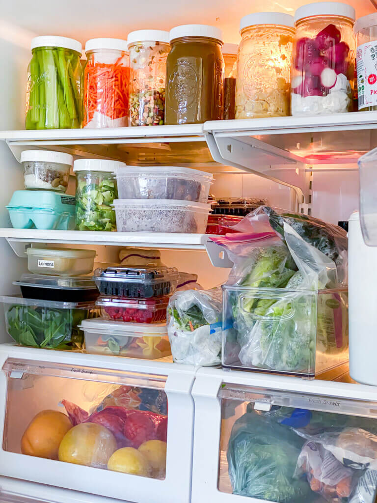Plant Based organized refrigerator using wide mouth Mason jars to organize cut up veggies and more to make plant based eating easier.