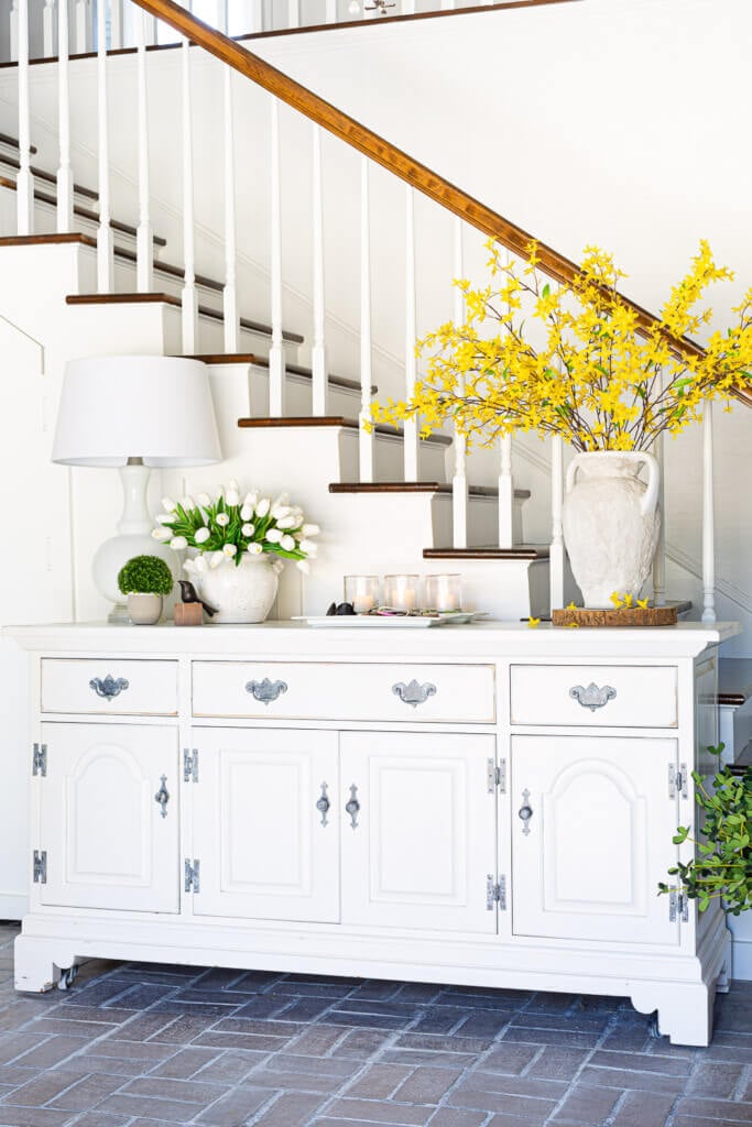 White dresser in foyer decorated for spring.
