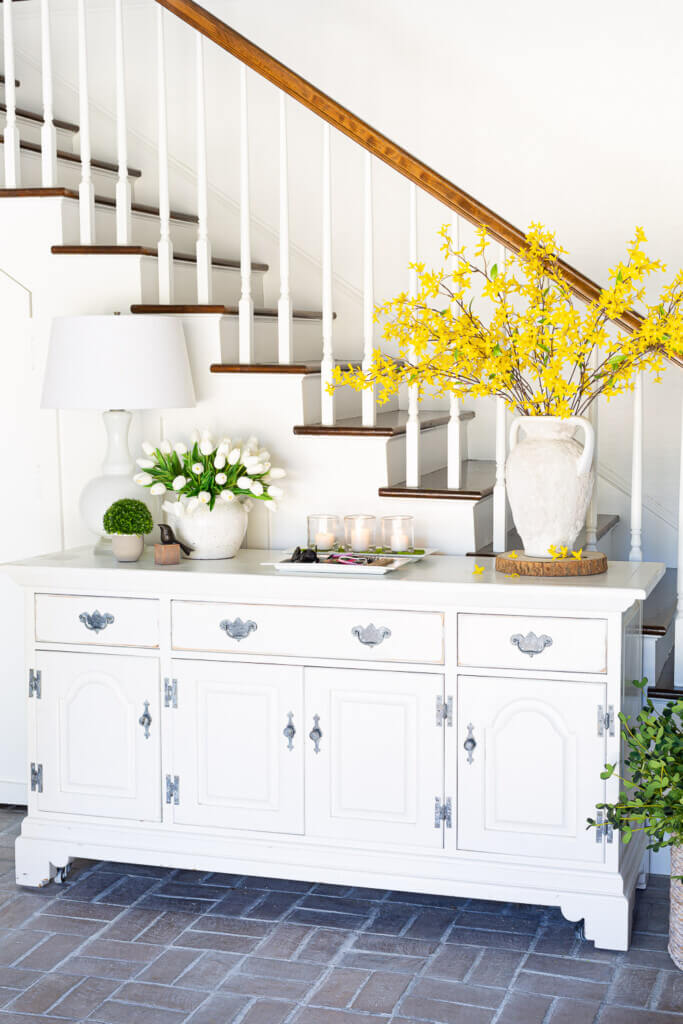 White dresser in foyer decorated for spring.