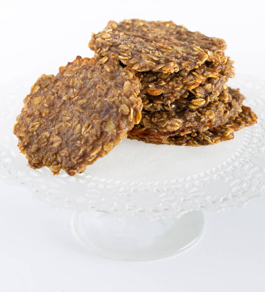 Healthy banana oatmeal cookies on a white plate stand.