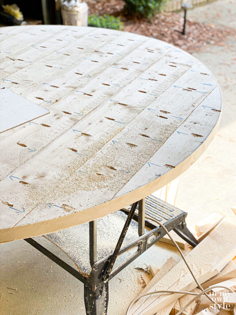 Underside of DIY round wood table made using 2 x 6 pine boards