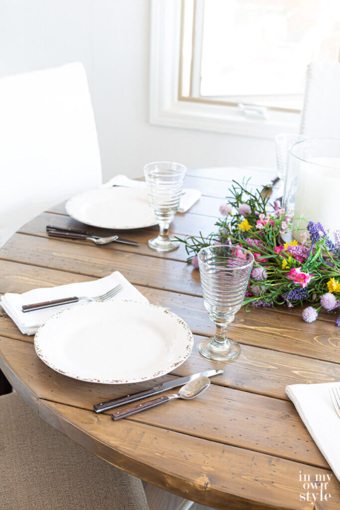 Completed DIY round wood table top set for dinner.