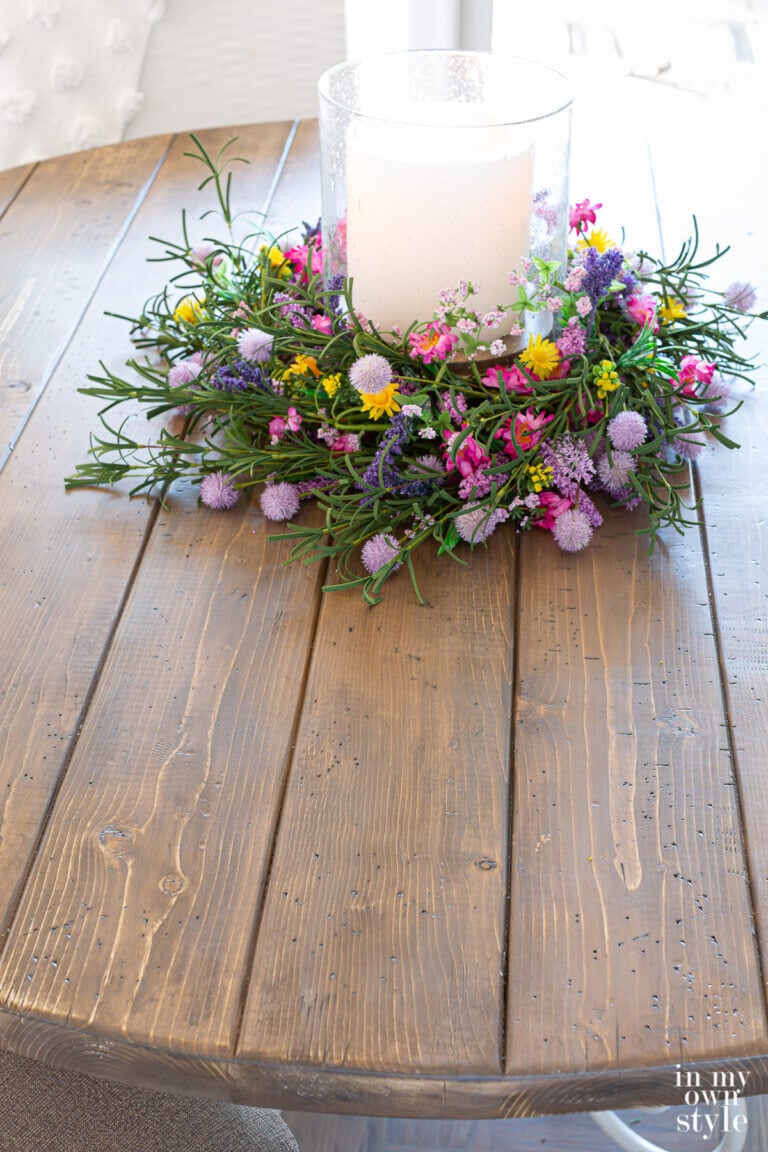 Completed DIY round wood table made using pine lumber.
