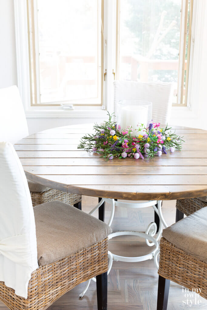 Completed DIY round wood table made using pine lumber.