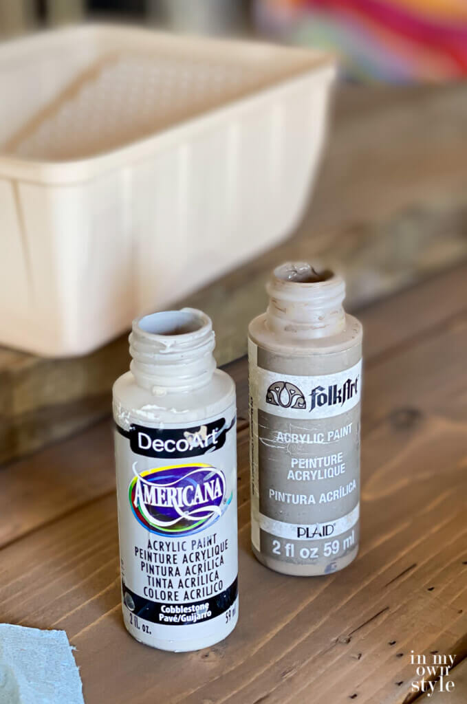 grey craft paints used to add a grey wash over a stained DIY round wood table top.