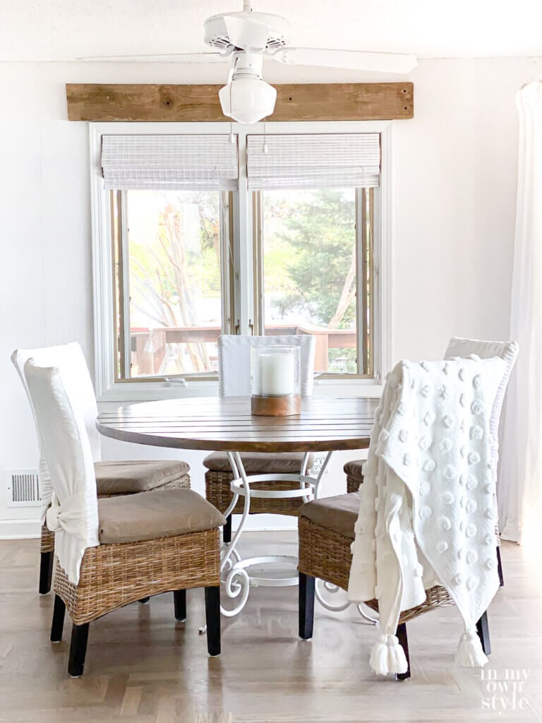 Newly made DIY pine wood board round table on white metal table base.