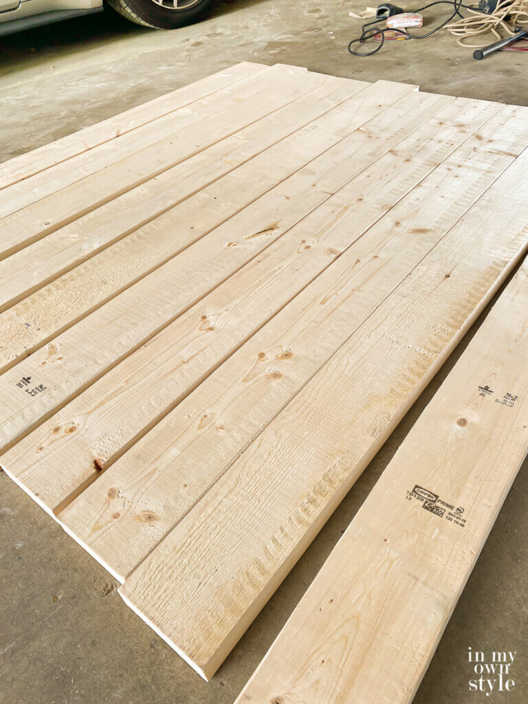 Lining up pine boards to make a DIY round wood table.