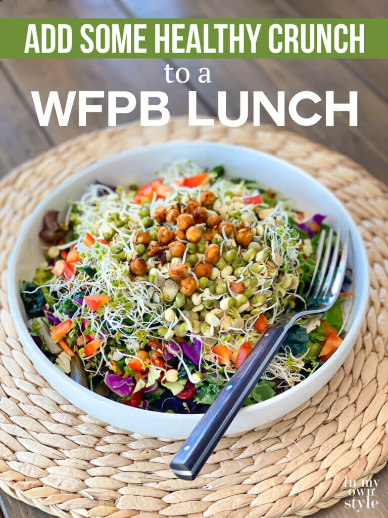 Salad bowl filled with chopped veggies and sprouts.