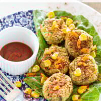 A plate on a table filled with Vegan mini crab cakes/