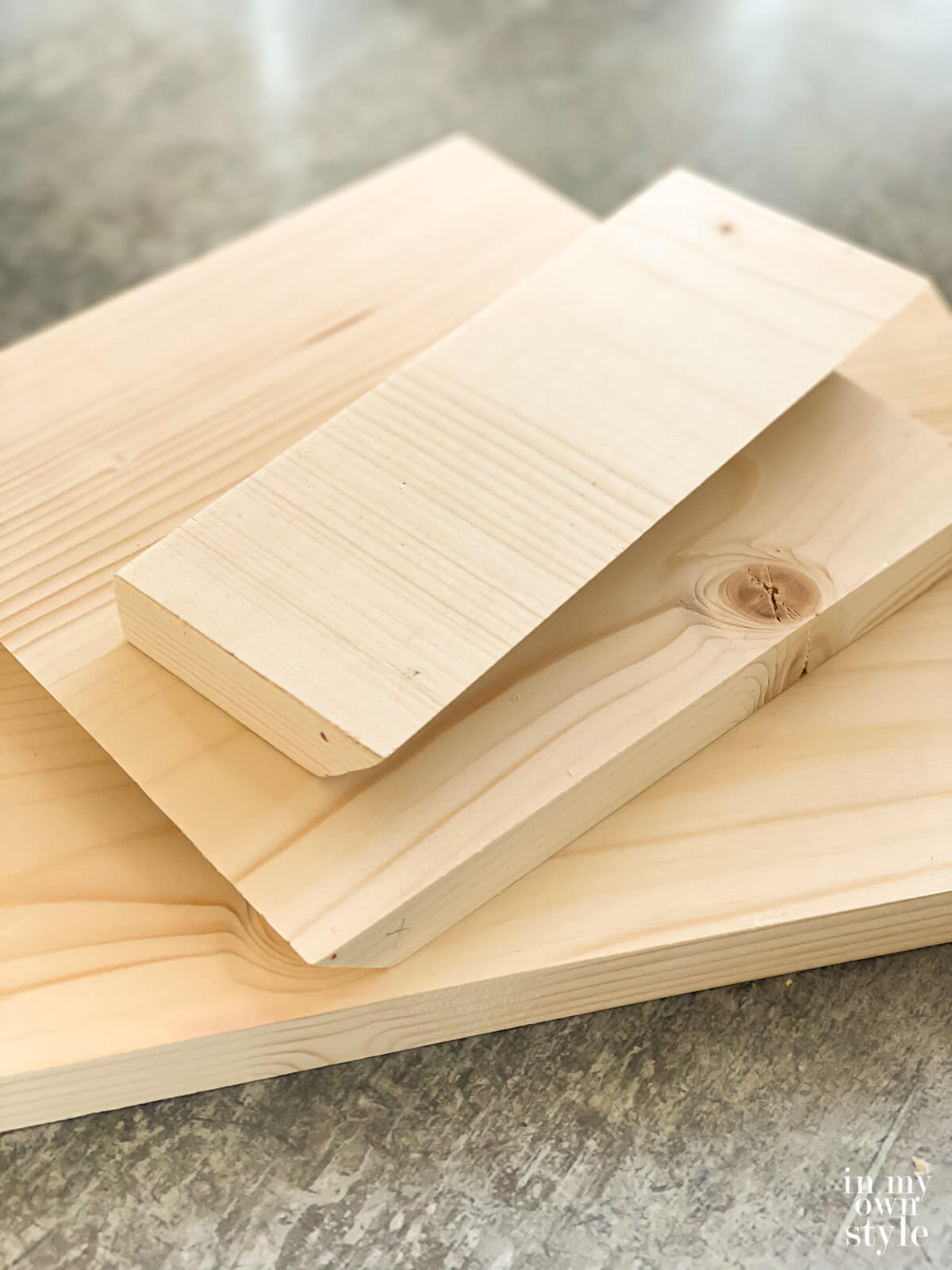 Scrap wood cut into pieces needed to make a x shape book stand for a table.