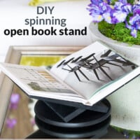 Black spinning open book stand on coffee table. Text overlay says: DIY spinning open book stand