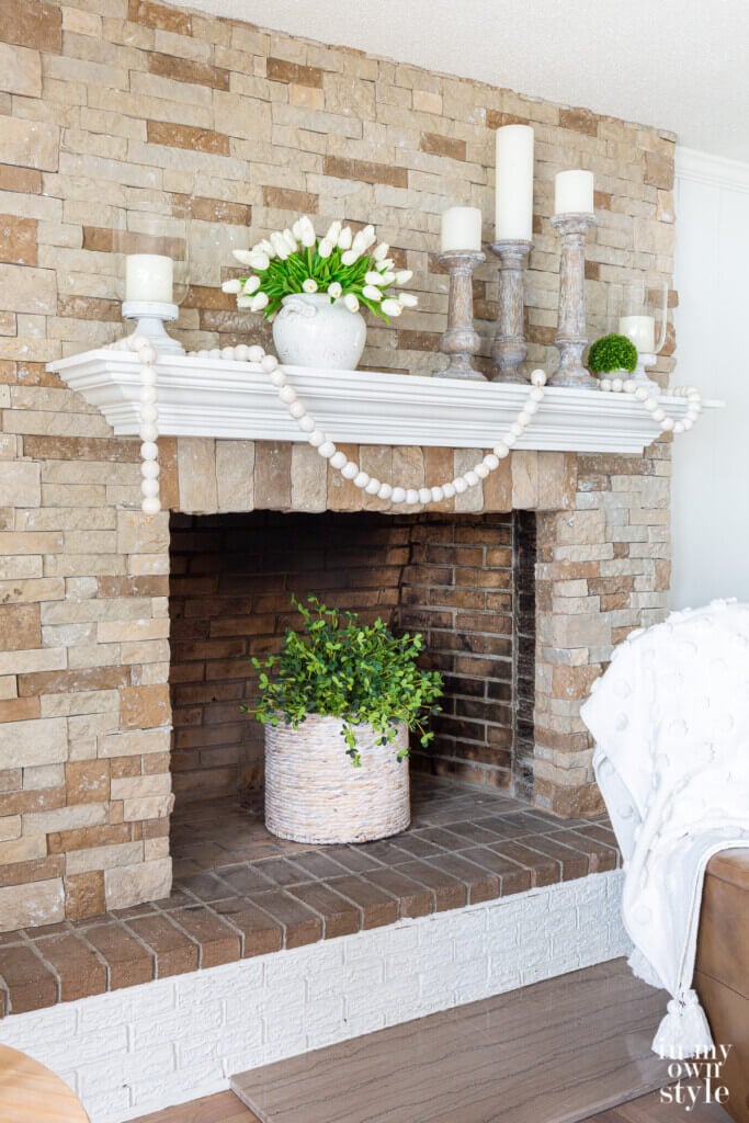 How to style a mantel for summer using neutral colors.