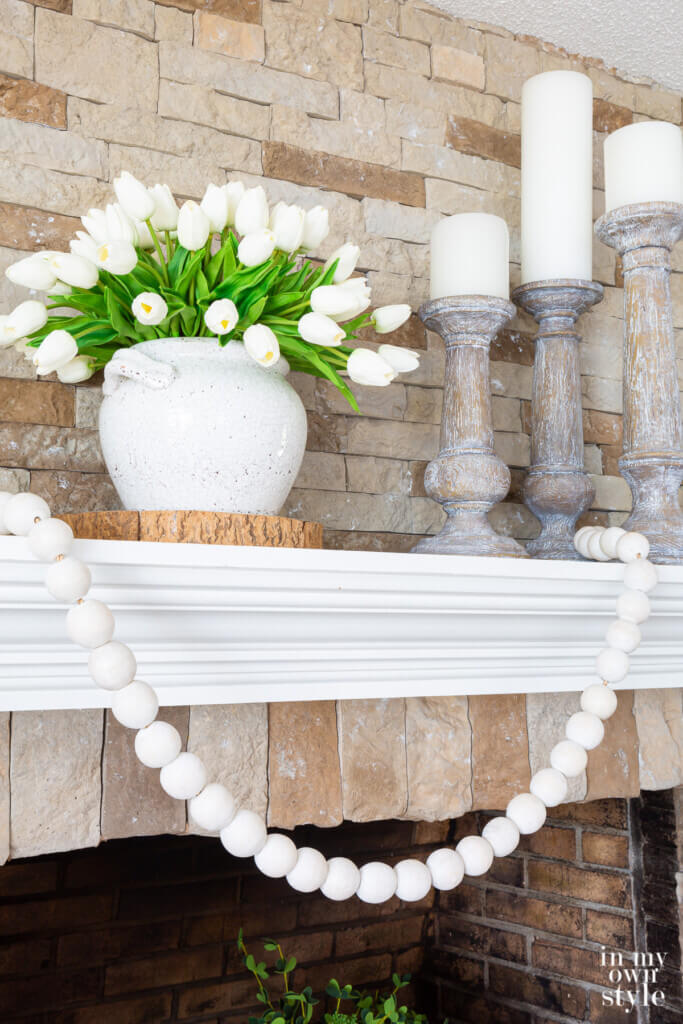 fireplace decorations on a mantel decorated for summer