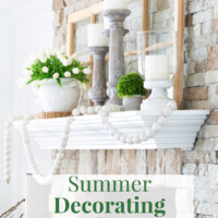 Green and white decorating color scheme on a fireplace mantel decorated for summer.