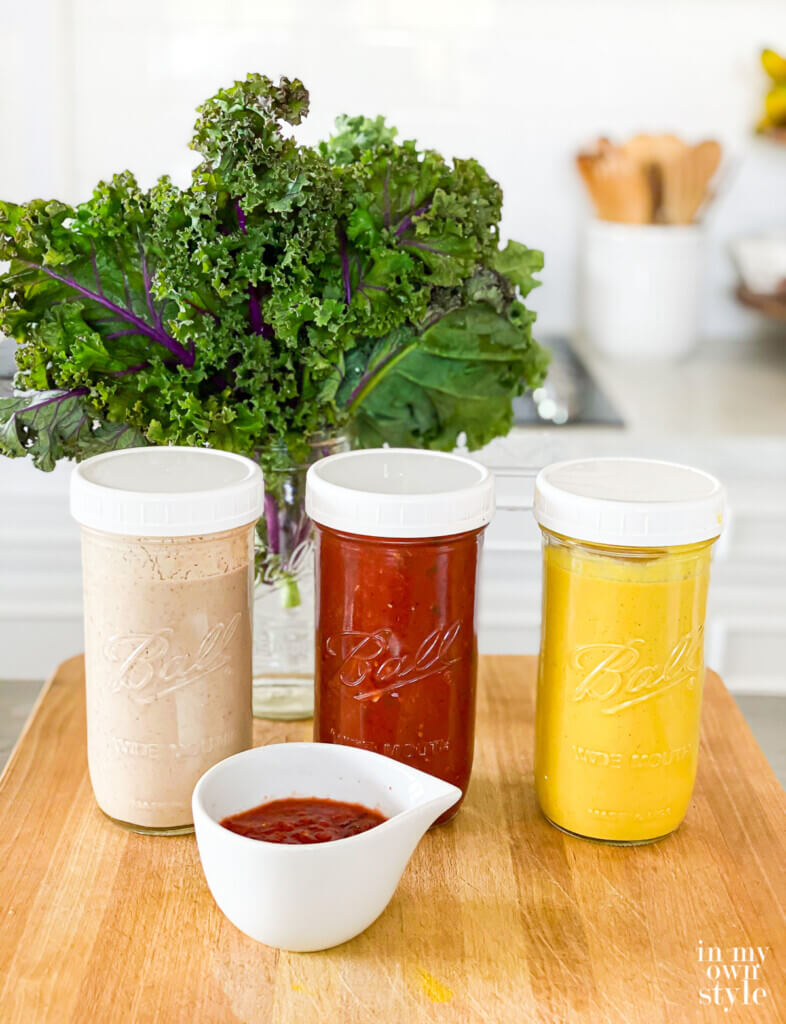 3 Whole Food Plant Based No Oil Sauces and Dressings in Mason Jars on kitchen counter.