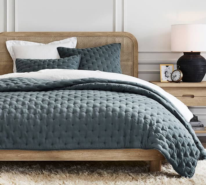 Pillow styling on a bed using an odd number of pillows.