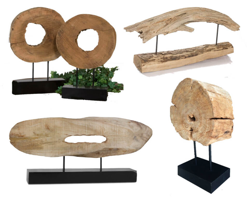 4 examples of driftwood or petrified wood sculptures on stands.