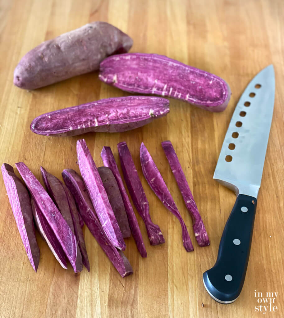 purple sweet potato sliced on cutting board.
