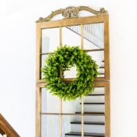 Two old wood window sashes made into a large mirror. Text overlay says Repurpose old wood windows.