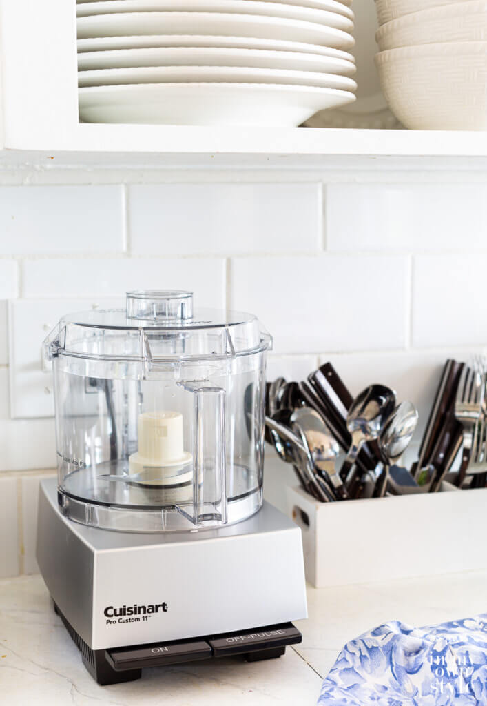 Kitchen countertop appliance organization Cuisinart Pro Custom 11 Food Processor on a counter in a small kitchen.