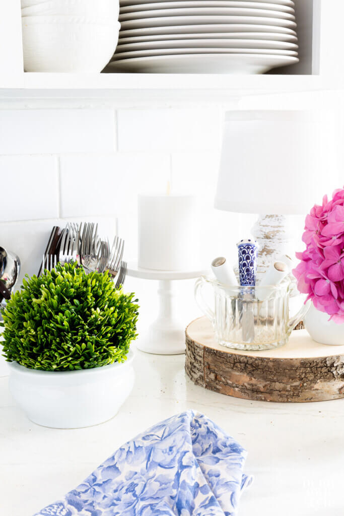 A few decorative items on a kitchen white counter.