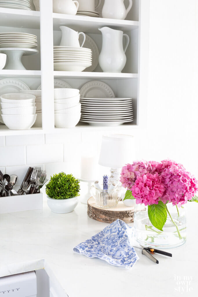 pretty decor on a counter in a white kitchen.