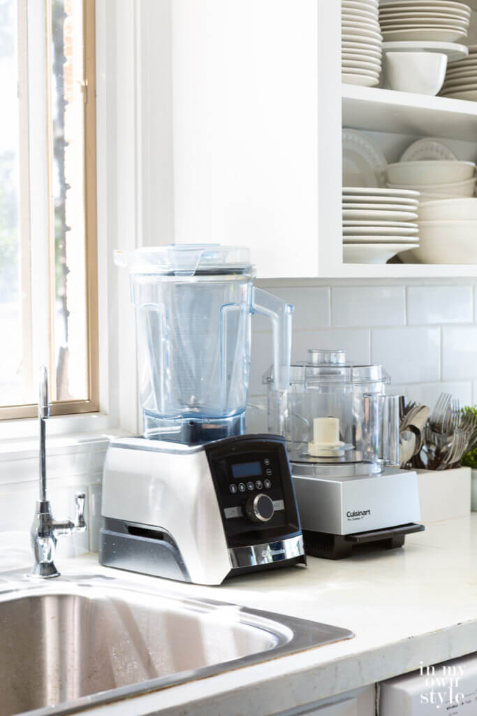 Vitamix blender and Cuisinart Food Processor on a kitchen counter.