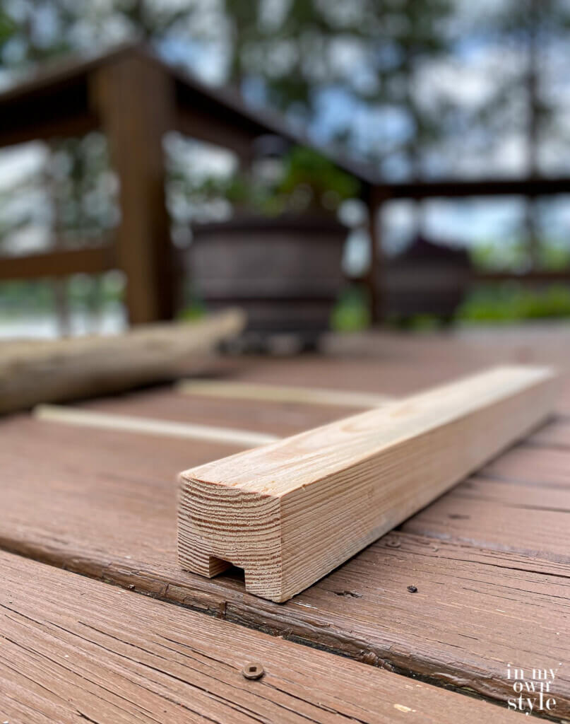 piece of wood and dowels to make a stand to make driftwood art.