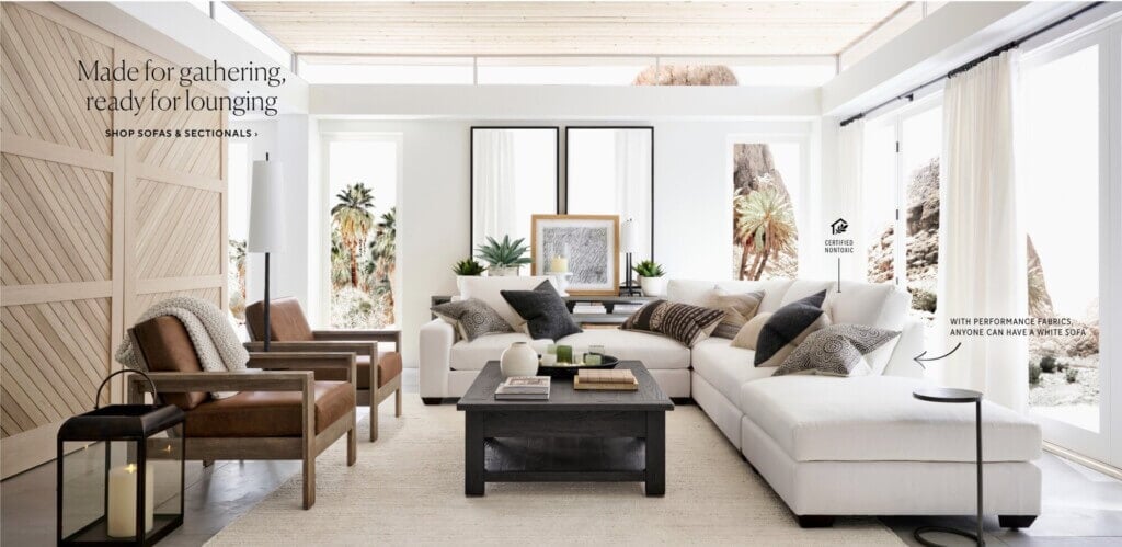 Pottery Barn room with two large mirrors placed behind a sofa.