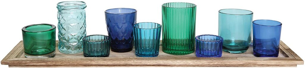 blue and turquoise glass votives on a wood tray