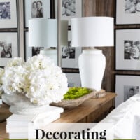 Living room console table in front of wall mirrors. Text overlay says Decorating using wall mirrors.