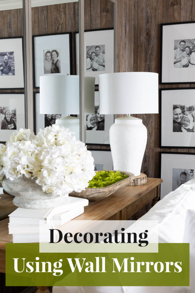 Living room console table in front of wall mirrors. Text overlay says Decorating using wall mirrors.